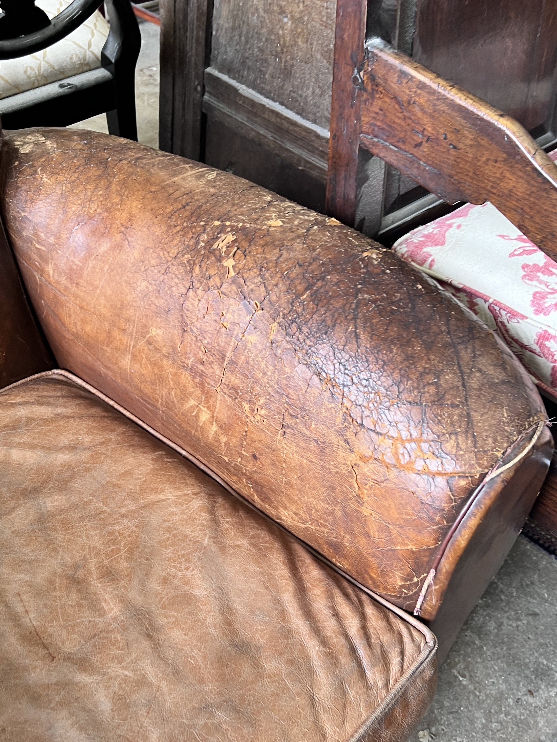 A mid century French tan leather club chair, width 94cm, depth 84cm, height 80cm